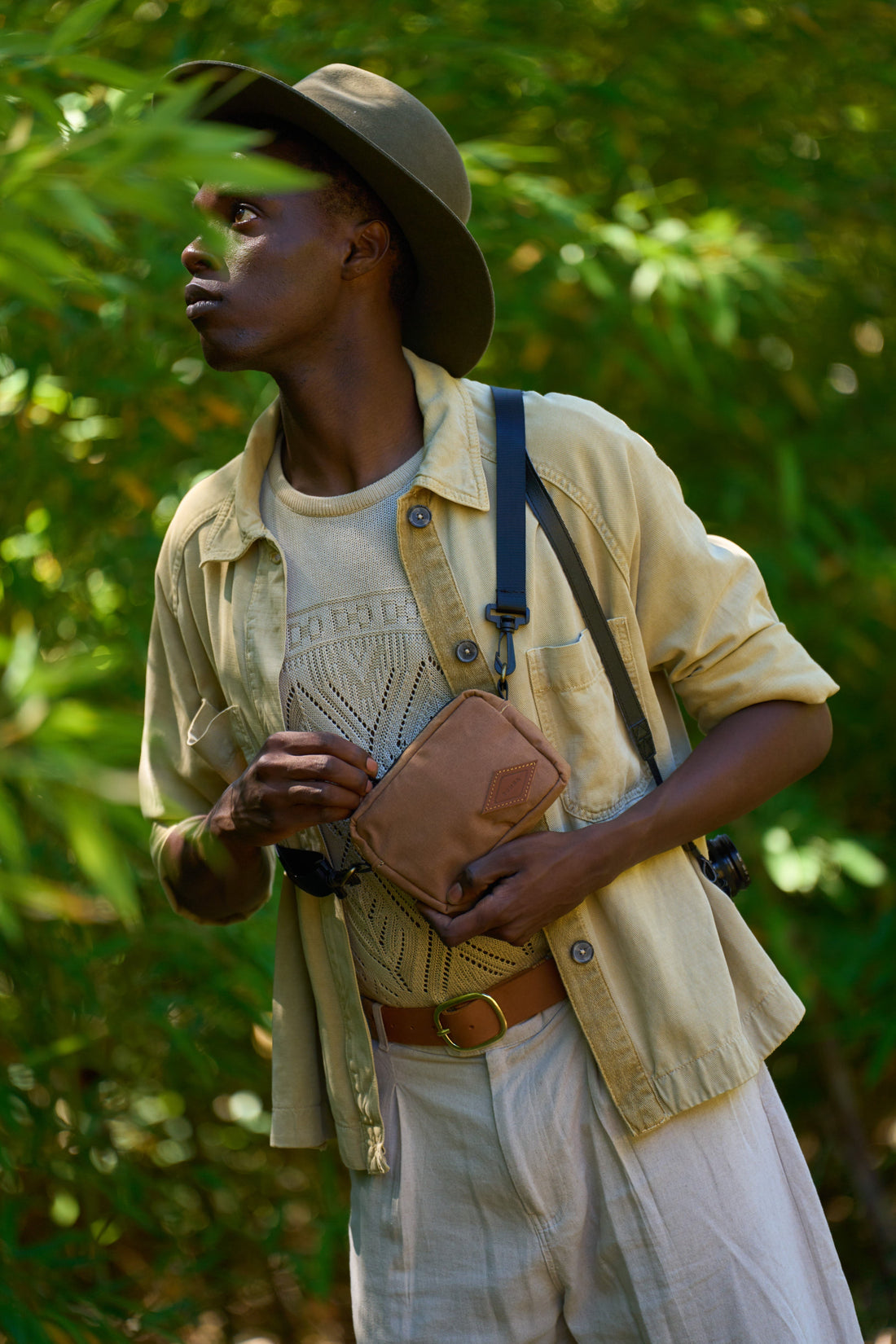 Man carrying a canvas safari bag on a bush walk, South Africa