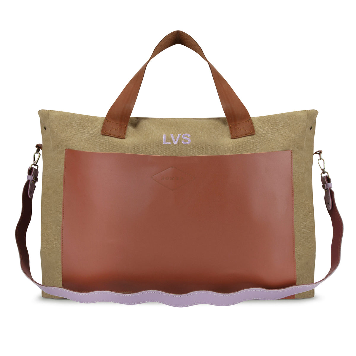 The LVS Betty in butterscotch canvas with a tan leather front pocket, LVS embroidered in lilac, and a wavy lilac and plum leather strap.